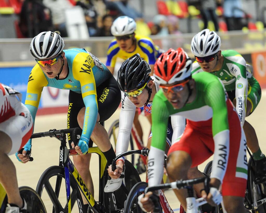 A group of cyclists wear custom cycling clothing racing